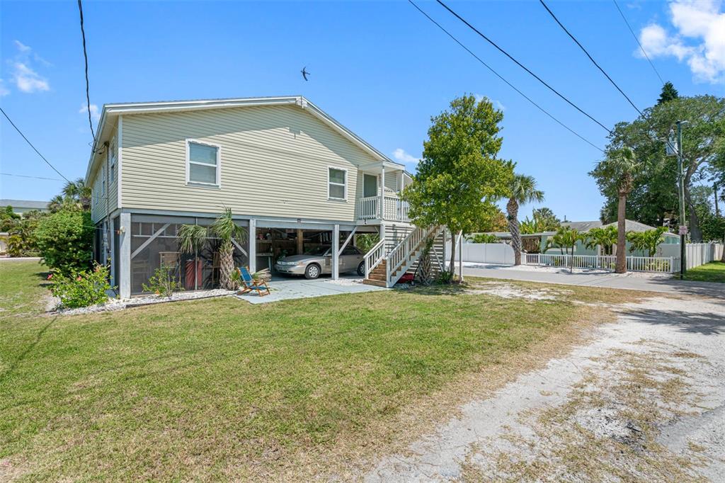 115 15th Avenue, Unit A Indian Rocks Beach, FL 33785 - Photo 33 of 65 a view of a house with backyard and a tree