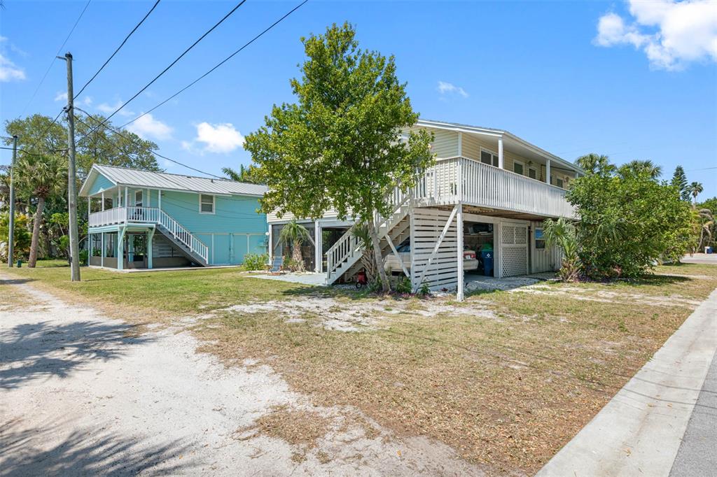 115 15th Avenue, Unit A Indian Rocks Beach, FL 33785 - Photo 34 of 65 a view of a house with a yard and garage