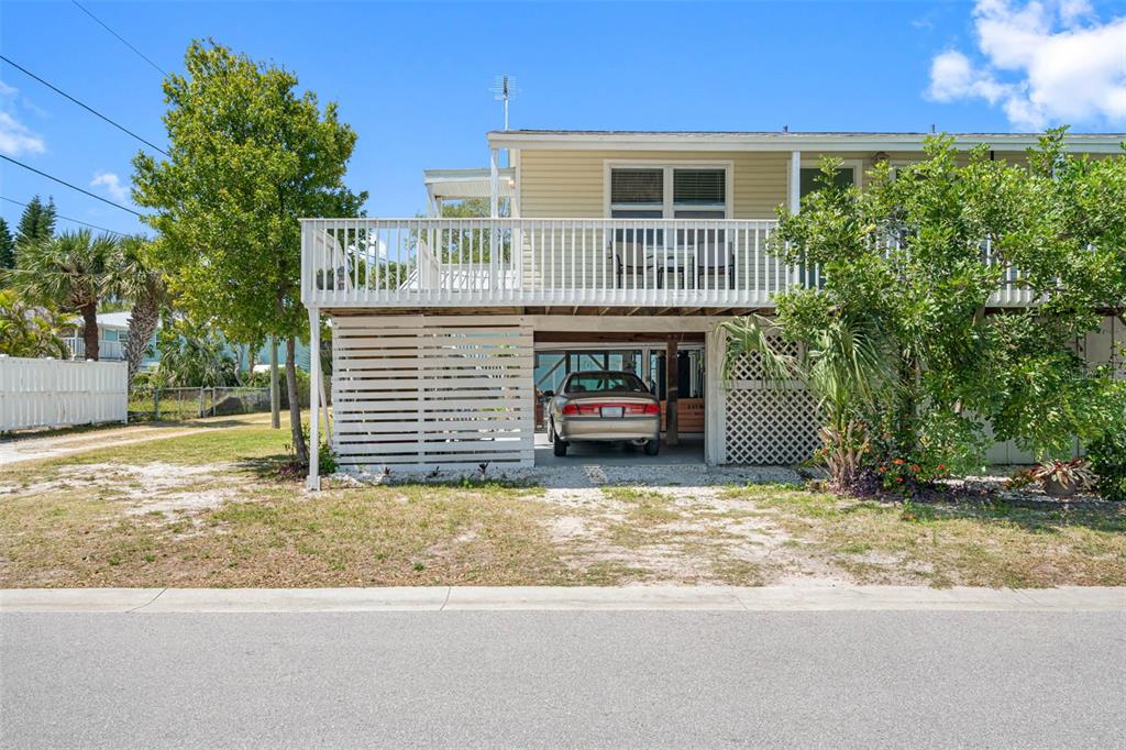 115 15th Avenue, Unit A Indian Rocks Beach, FL 33785 - Photo 35 of 65 a view of a house with a yard and garage