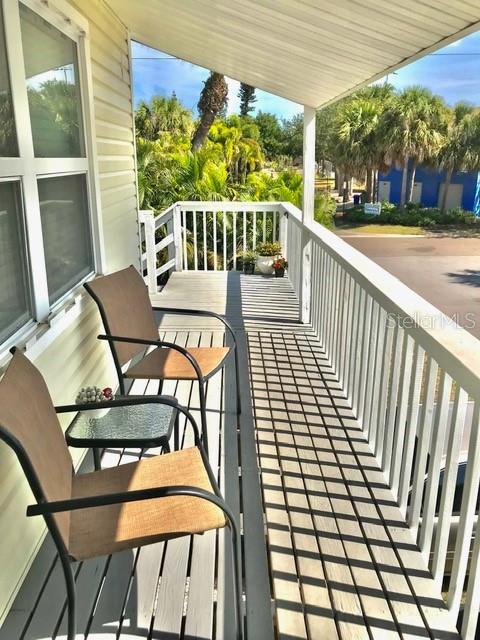 115 15th Avenue, Unit A Indian Rocks Beach, FL 33785 - Photo 6 of 65 a view of a chairs and table in the balcony