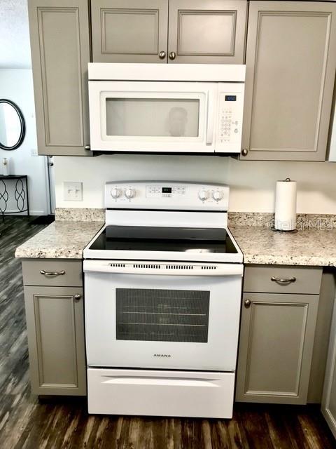 115 15th Avenue, Unit A Indian Rocks Beach, FL 33785 - Photo 9 of 65 a stove top oven sitting inside of a kitchen