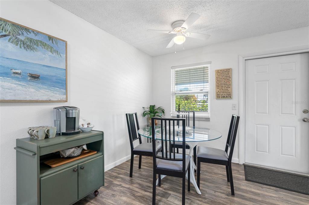 115 15th Avenue, Unit A Indian Rocks Beach, FL 33785 - Photo 10 of 65 a view of a dining room with furniture and wooden floor
