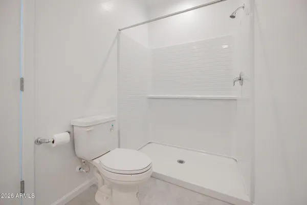a bathroom with a toilet and shower