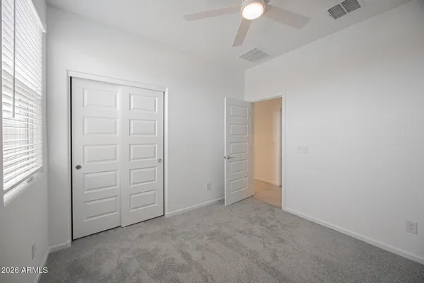 an empty room with closet area