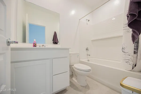 a bathroom with a sink toilet vanity and tub
