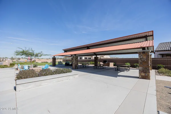 a roof deck with table and chairs potted plants with wooden floor and potted plants