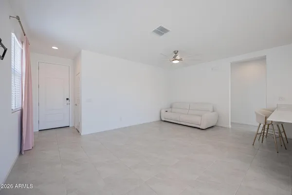 a view of livingroom and a chandelier fan