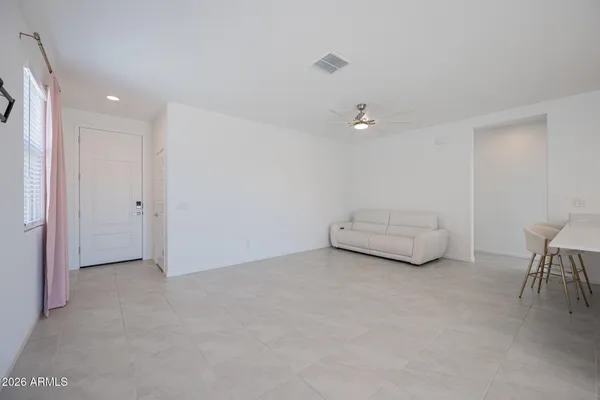 a view of livingroom and a chandelier fan