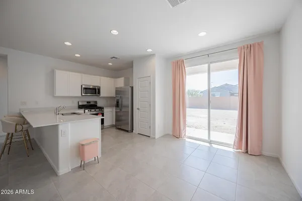 a kitchen with refrigerator and cabinets