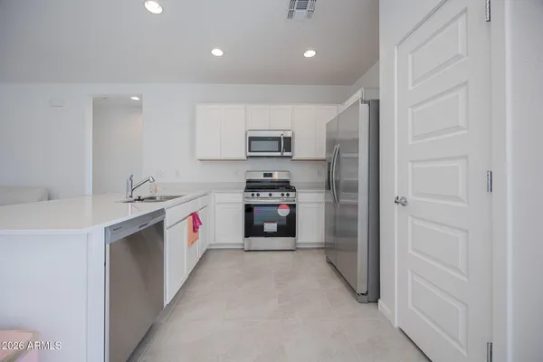 a kitchen with a sink and a refrigerator