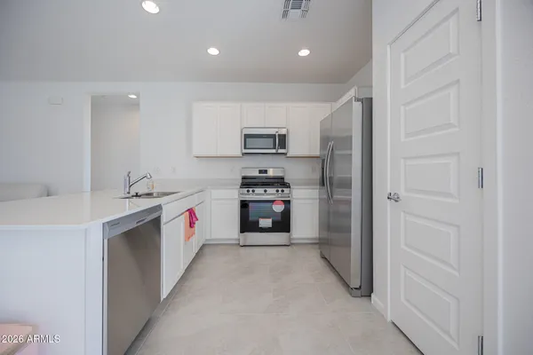 a kitchen with a sink and a refrigerator