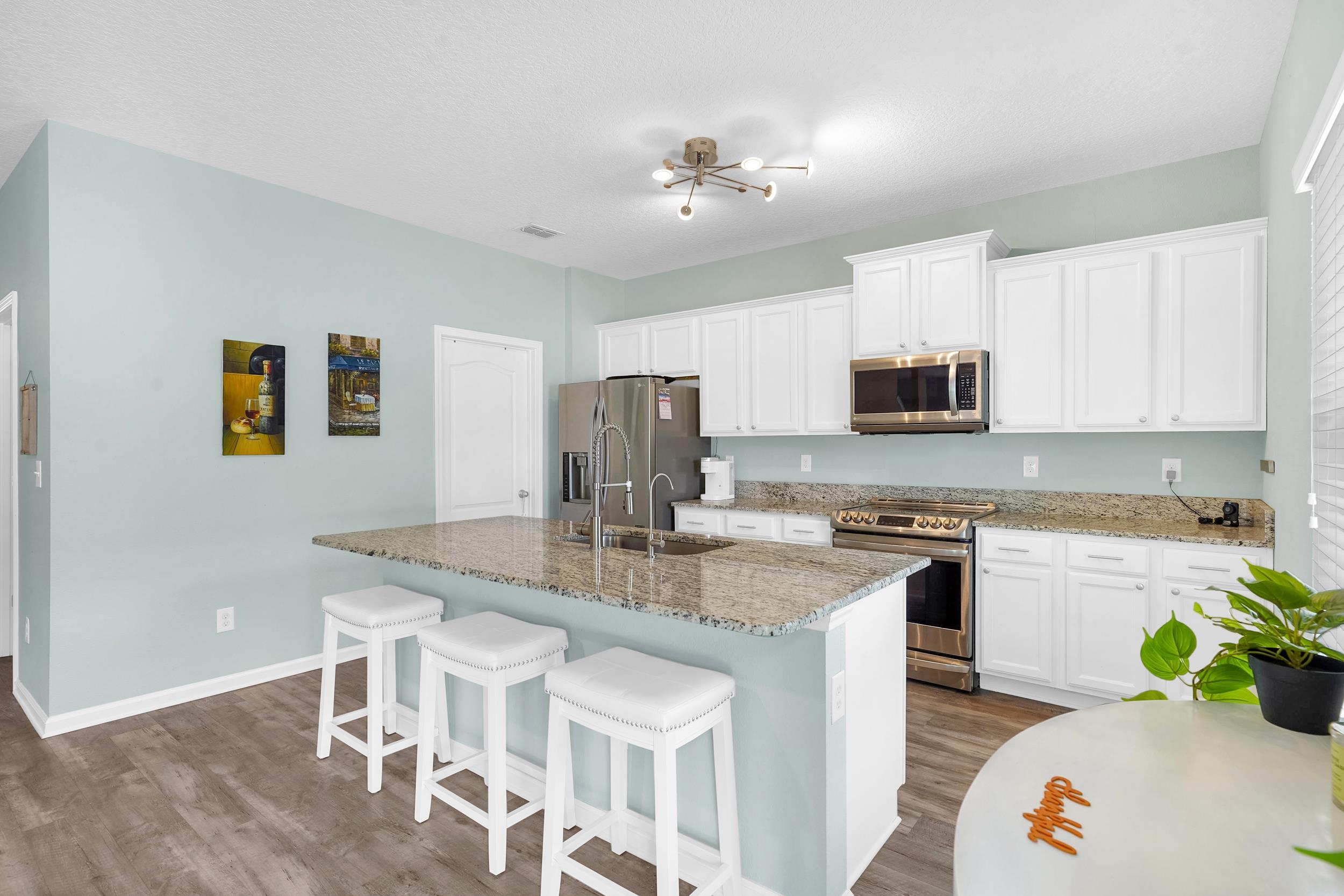 167 Codman Drive St. Augustine, FL 32084 - Photo 17 of 40 a kitchen with kitchen island granite countertop a sink cabinets and stainless steel appliances