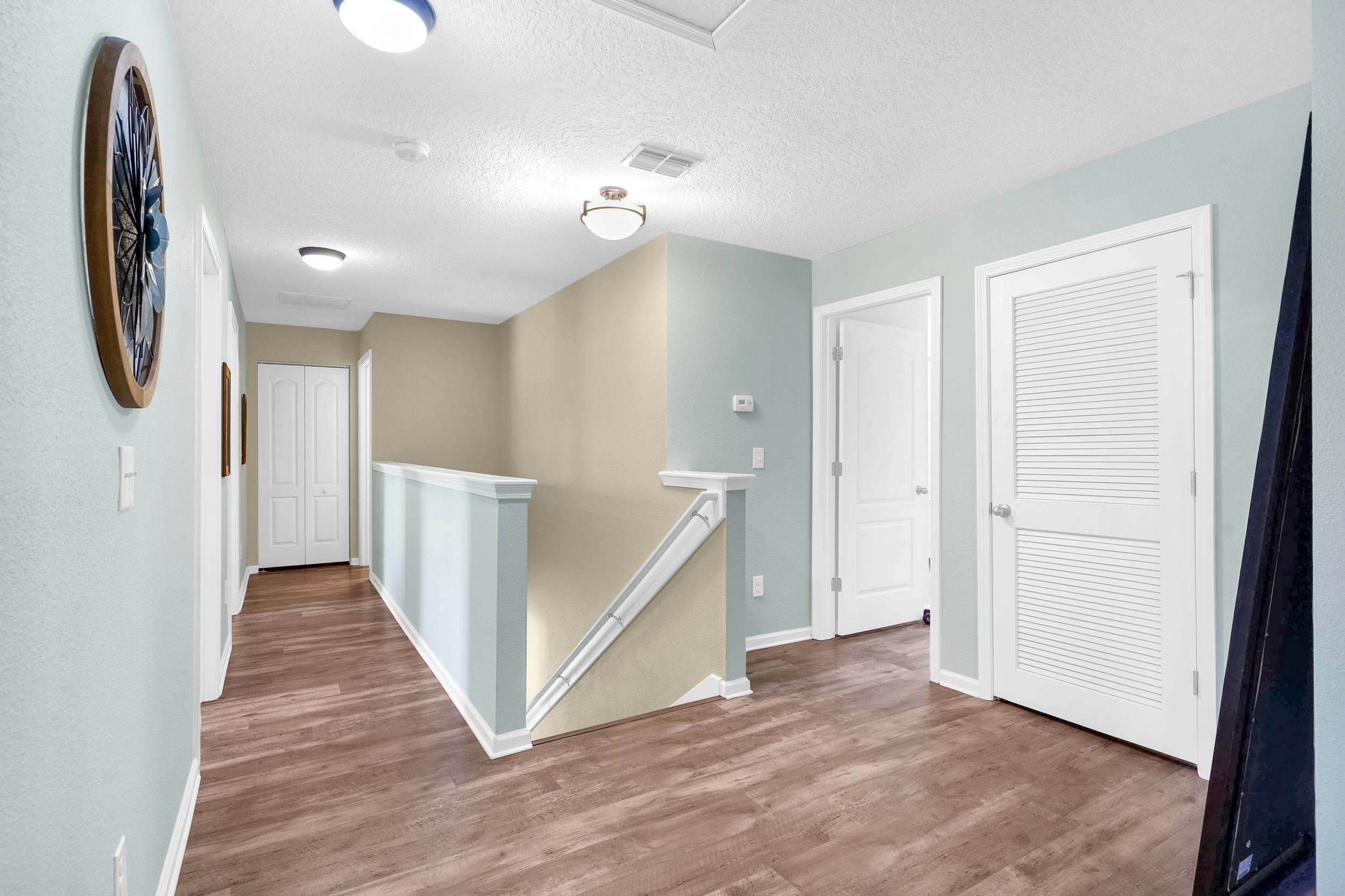 167 Codman Drive St. Augustine, FL 32084 - Photo 18 of 40 a view of a hallway with wooden floor and staircase