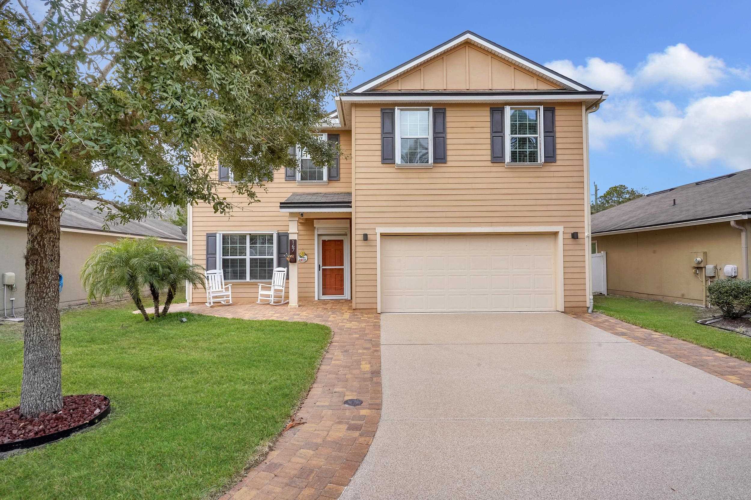 167 Codman Drive St. Augustine, FL 32084 - Photo 3 of 40 a front view of a house with a yard and garage