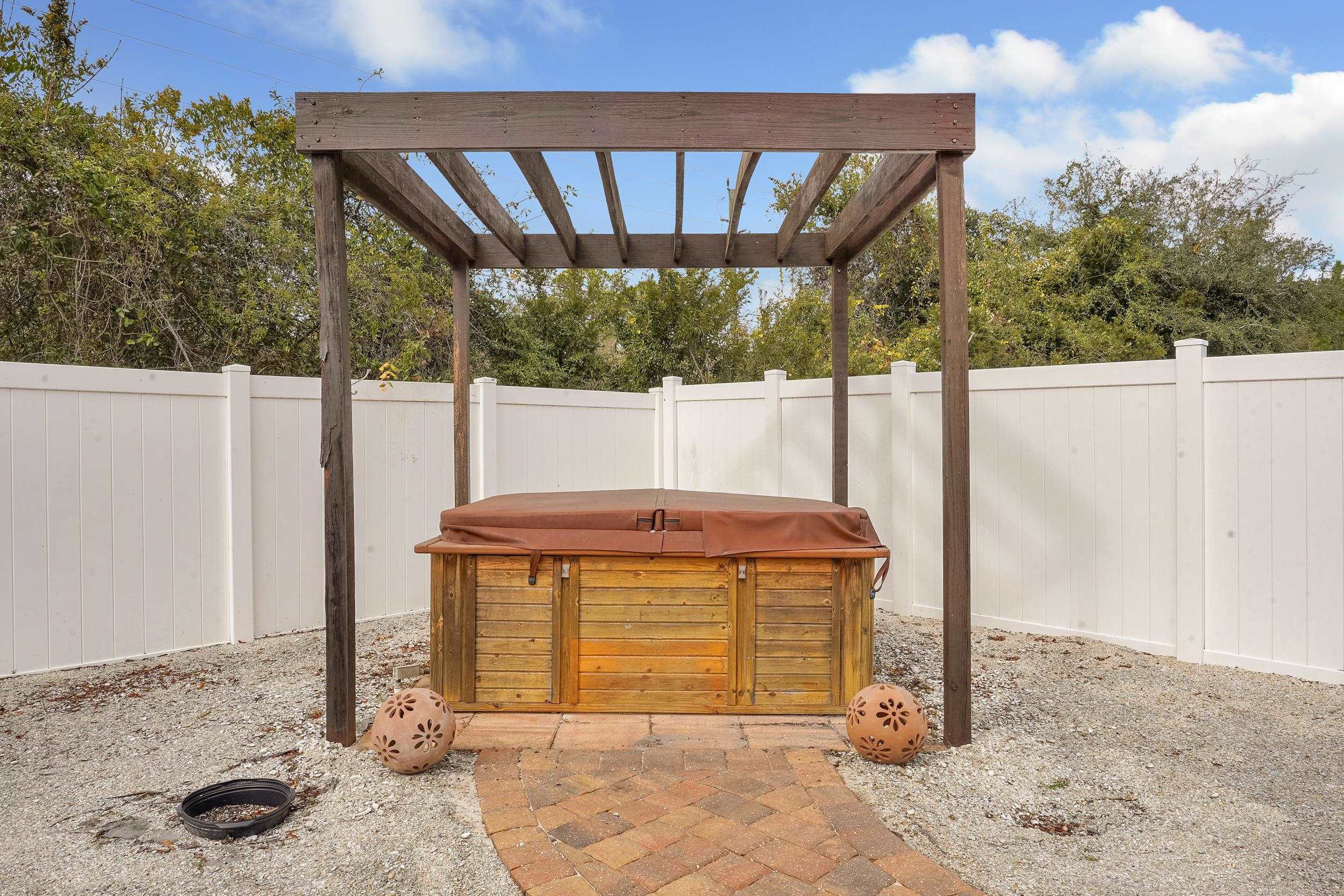 167 Codman Drive St. Augustine, FL 32084 - Photo 36 of 40 Fenced backyard featuring a hot tub and a pergola