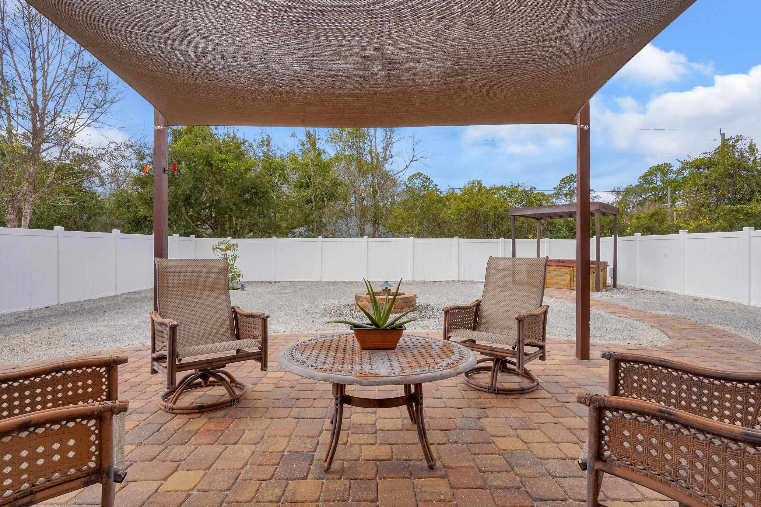 167 Codman Drive St. Augustine, FL 32084 - Photo 36 of 40 a view of a patio with a table chairs and a potted plant