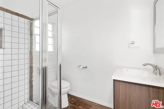 a bathroom with a shower and a sink