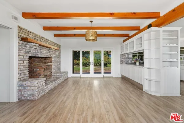 a view of wooden floor and a fireplace in a room