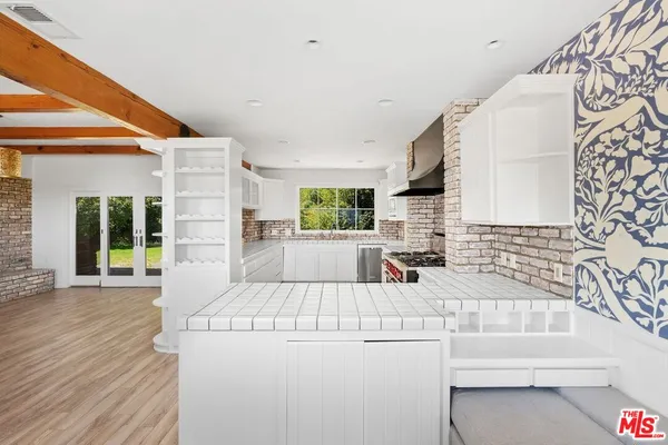 a kitchen with a sink a stove and a refrigerator