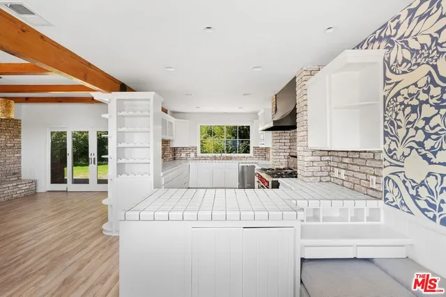 a kitchen with a sink a stove and a refrigerator
