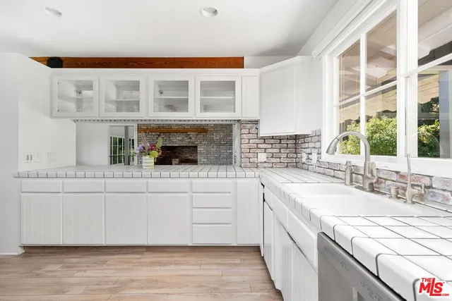 a kitchen with stainless steel appliances granite countertop a sink and cabinets
