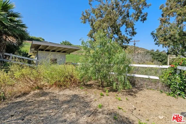 a backyard of a house with lots of green space