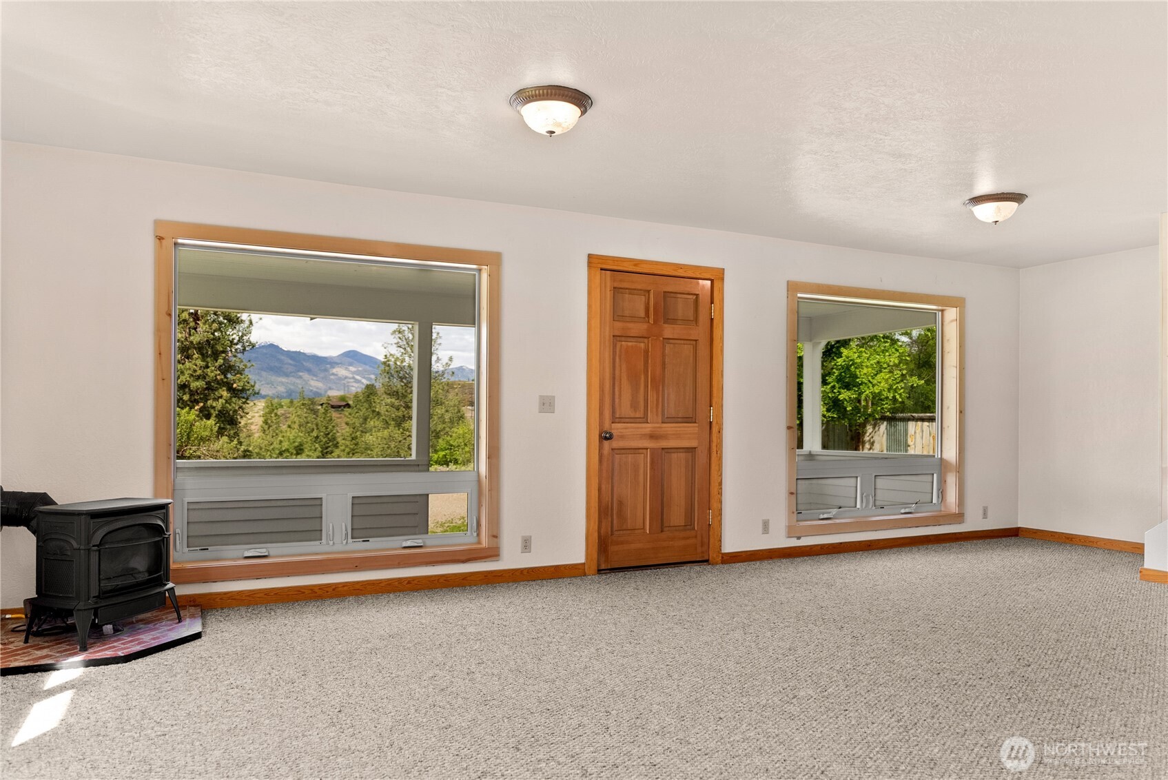 511 Bluff Street Winthrop, WA 98862 - Photo 6 of 38 a view of a livingroom with furniture a fireplace and window