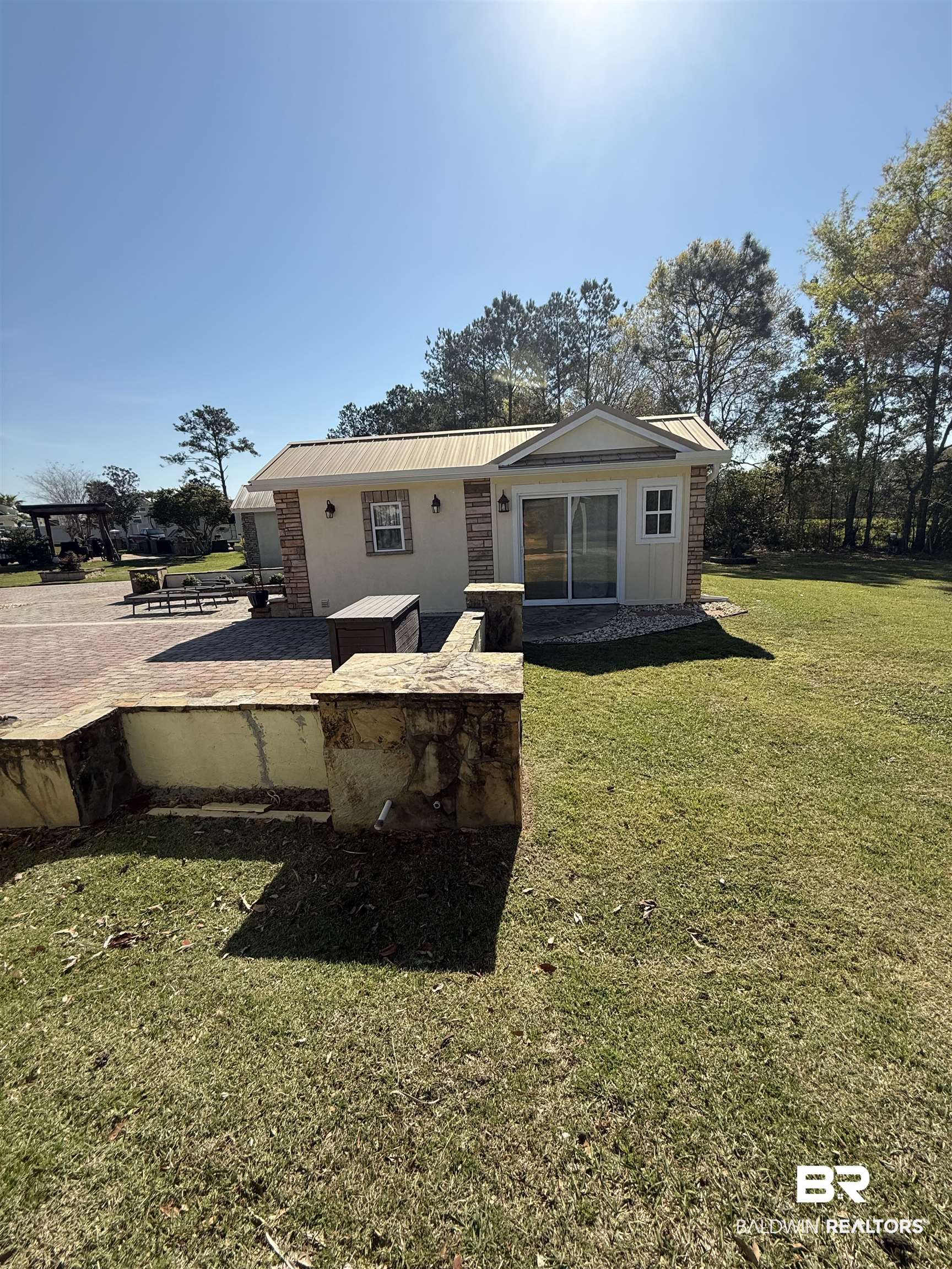 28114 Preserve Trail, Unit 190 Elberta, AL 36530 - Photo 18 of 69 Rear view of property featuring a yard, a metal roof, and a patio area