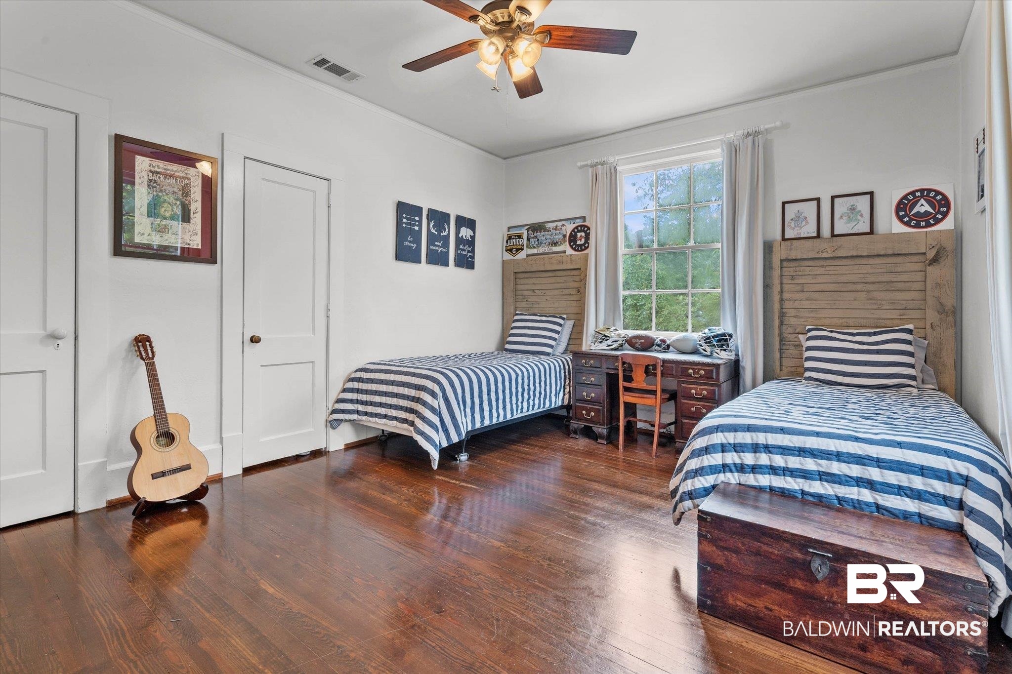 3863 Old Shell Road Mobile, AL 36608 - Photo 27 of 48 Spacious room featuring rich wood-finish flooring, a large window, a ceiling fan, and two paneled doors