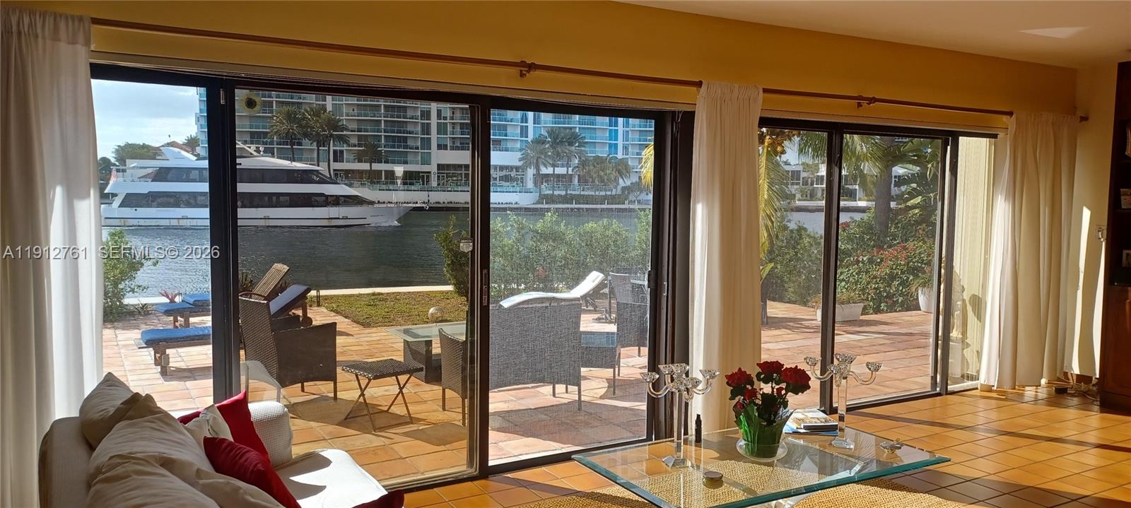 363 Centre Island Golden Beach, FL 33160 - Photo 11 of 31 a living room filled with furniture and a floor to ceiling window