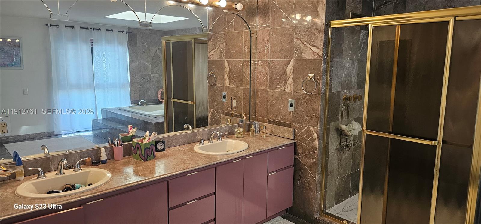 363 Centre Island Golden Beach, FL 33160 - Photo 14 of 31 a bathroom with a shower sink vanity granite and mirror