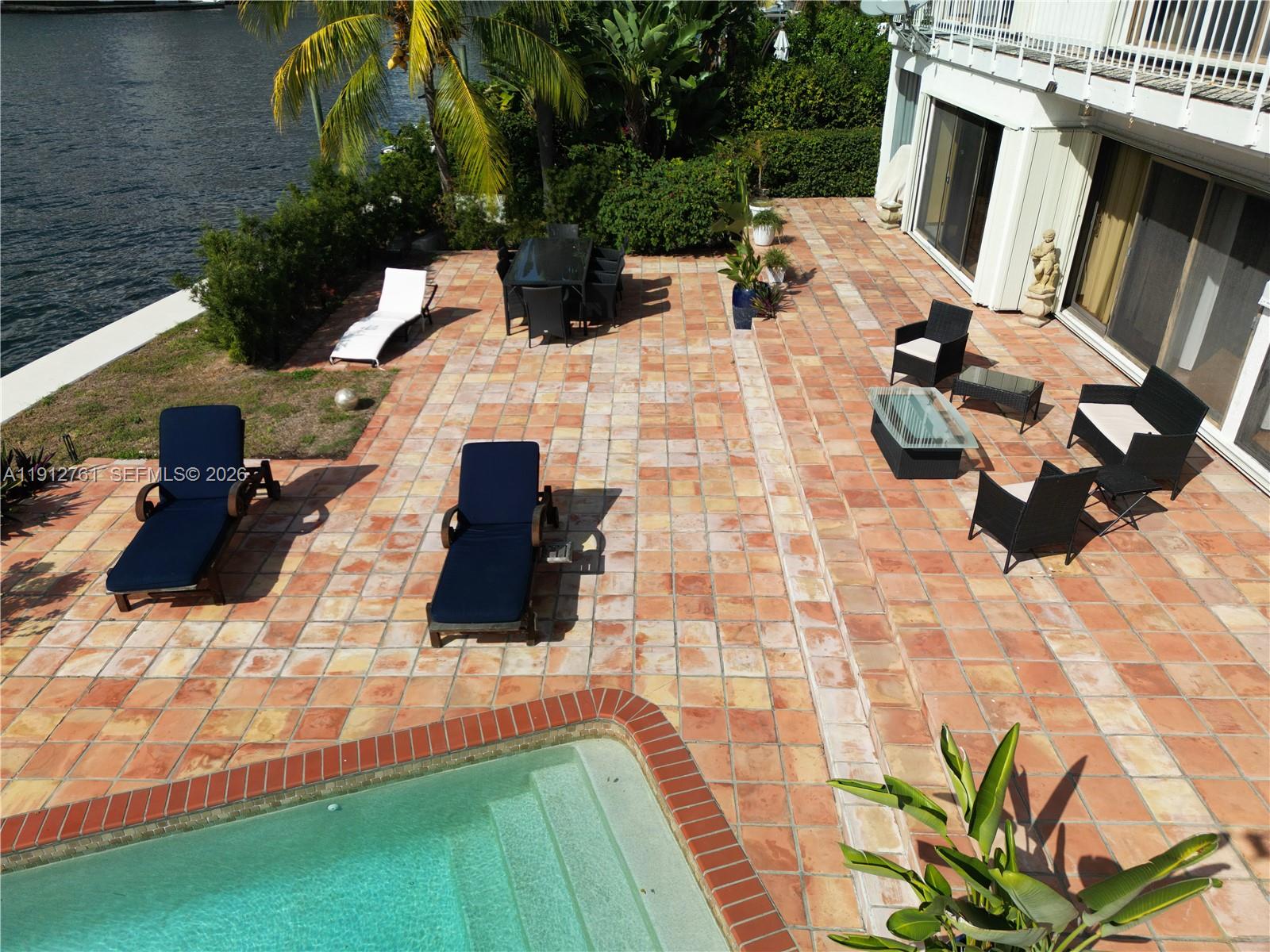 363 Centre Island Golden Beach, FL 33160 - Photo 17 of 31 a white bench sitting in the middle of a yard