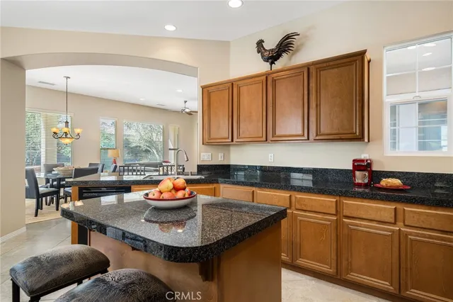 a kitchen with stainless steel appliances granite countertop a sink refrigerator and cabinets