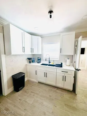 a kitchen with white cabinets and white appliances