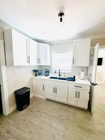 a kitchen with white cabinets and white appliances