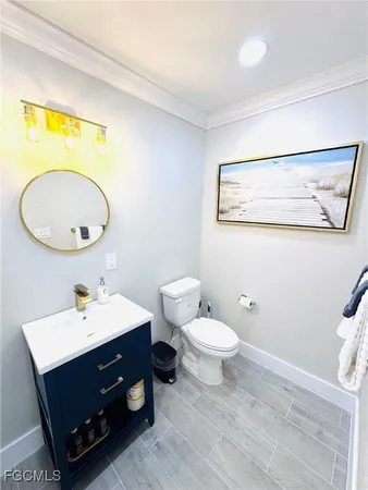 a bathroom with a sink mirror and toilet