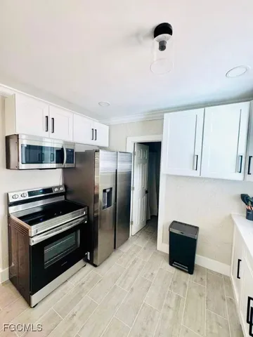 a kitchen with stainless steel appliances a refrigerator and a stove top oven