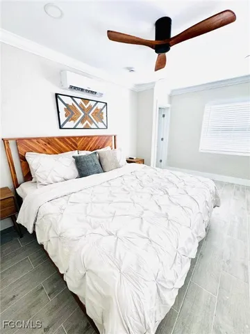 a bedroom with a bed and painting on the wall