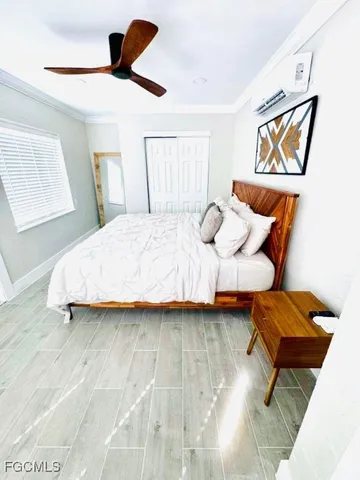 a bedroom with a bed and wooden floor