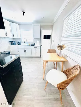 a living room with furniture and a kitchen view