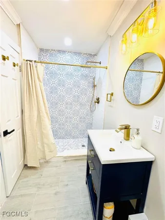 a bathroom with a sink vanity and a mirror
