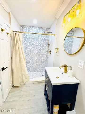 a bathroom with a sink vanity and a mirror