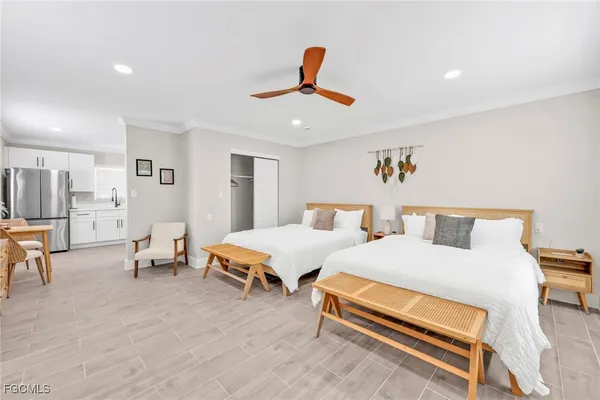 a bedroom with two beds and a chandelier
