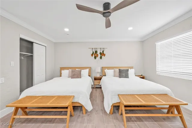 a bedroom with two beds and painting on the wall