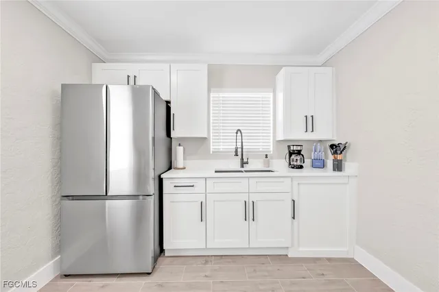 a kitchen with stainless steel appliances a refrigerator sink and cabinets