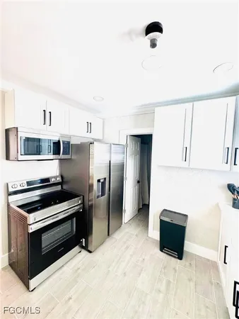 a kitchen with stainless steel appliances a refrigerator and a stove top oven