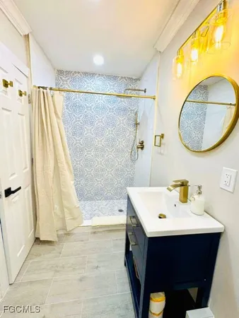 a bathroom with a sink vanity and a mirror