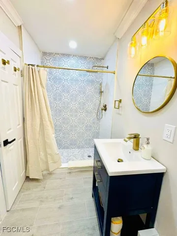 a bathroom with a sink vanity and a mirror