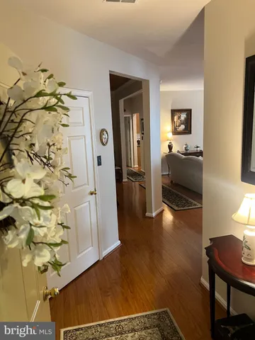 a view of a hallway to a livingroom with furniture