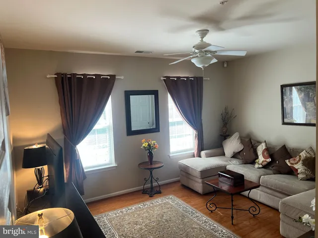 a living room with furniture a window and a chandelier
